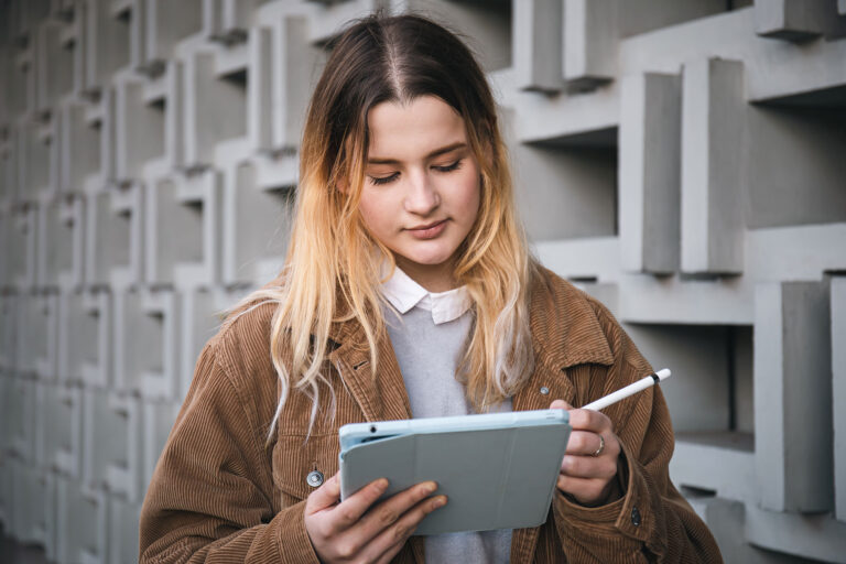 Young women reading e-brochure on ipad, Construction site in background